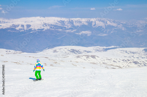 Girl snowboarding on the ski slope in Tsakhkadzor (Tsaghkadzor), Kotayk Province, Armenia