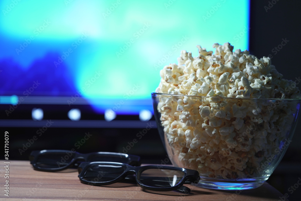 glass bowl with popcorn in the background works TV. glass bowl with popcorn in the background works TV.