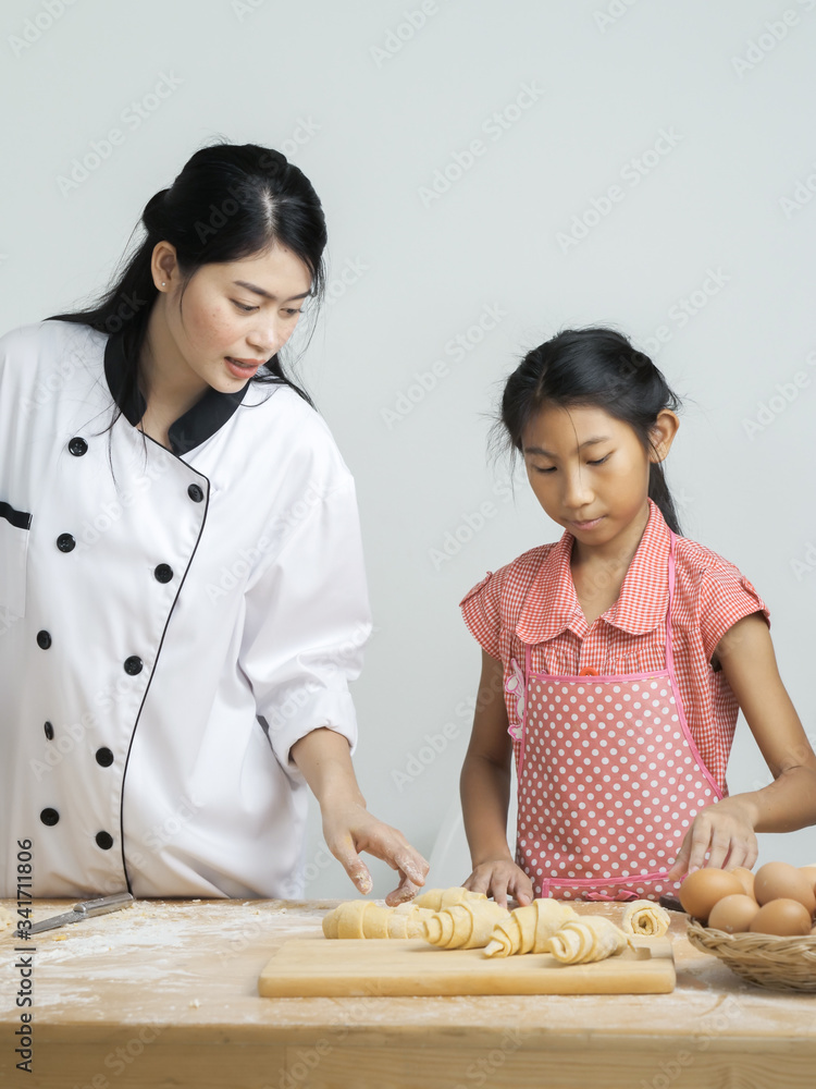 Asian girl learning with chef, how to processing croissant, lifestyle concept. Asian girl learning with chef, how to processing croissant, lifestyle concept.