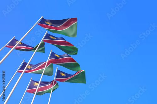 Nigeria flags waving in the wind against a blue sky. 3D Rendering