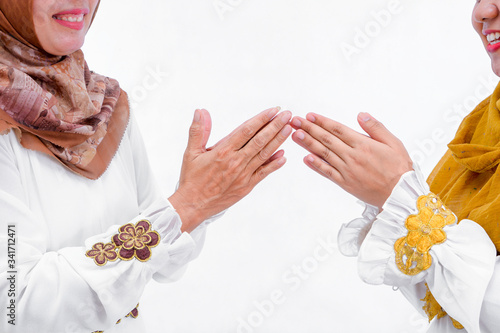 portrait of daughters and mothers greet each other apologizing isolated over white background photo