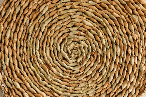 Wicker stand for hot dishes. Pattern of straw. Top view.