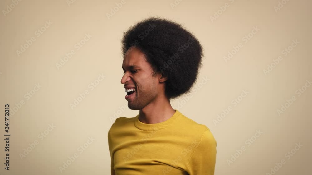 African young man is dancing with joy in studio shot. Shot with RED helium camera in 8K. African young man is dancing with joy in studio shot. Shot with RED helium camera in 8K.