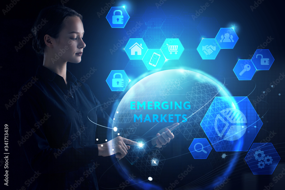 Business, Technology, Internet and network concept. Young businessman working on a virtual screen of the future and sees the inscription: Emerging markets Business, Technology, Internet and network concept. Young businessman working on a virtual screen of the future and sees the inscription: Emerging markets
