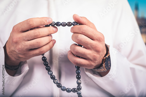 Arabic man hand holding a muslim rosary. ramadan holy month, .Ramadhan kareem concept.