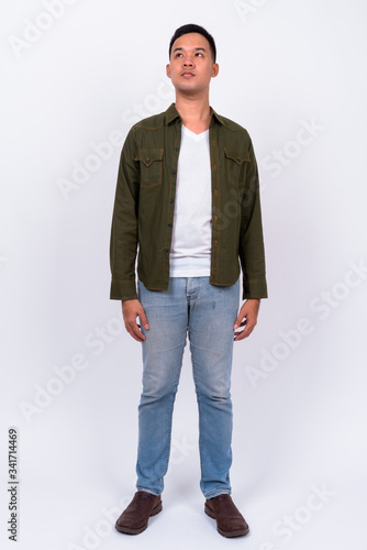 Full body shot of young Asian man wearing jacket © Ranta Images