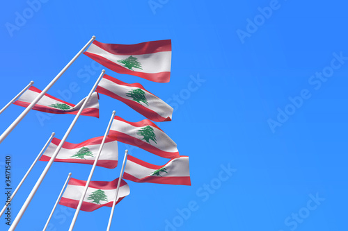 Lebanon flags waving in the wind against a blue sky. 3D Rendering