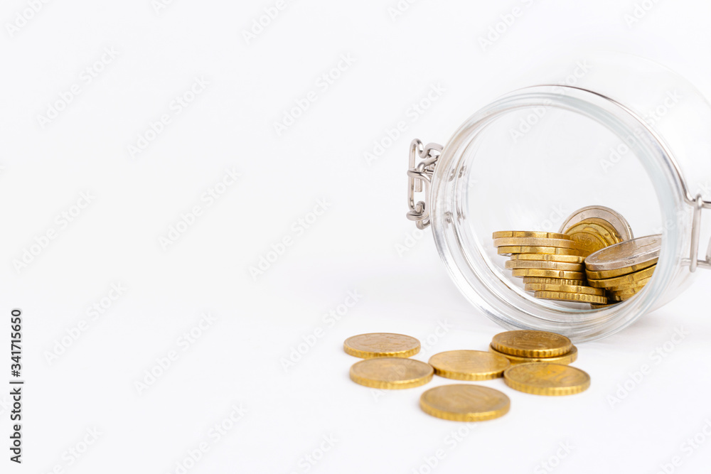 Glass jar with golden coins at white background. Bankruptcy concept. Glass jar with golden coins at white background. Bankruptcy concept.