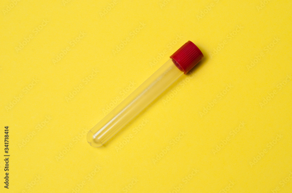 One blood collection tube on a yellow background One blood collection tube on a yellow background