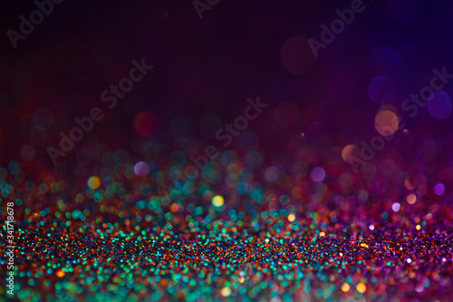 Decoration bokeh glitters background, abstract blurred backdrop with circles,modern design overlay with sparkling glimmers. Black, purple and green backdrop glittering sparks with blur effect