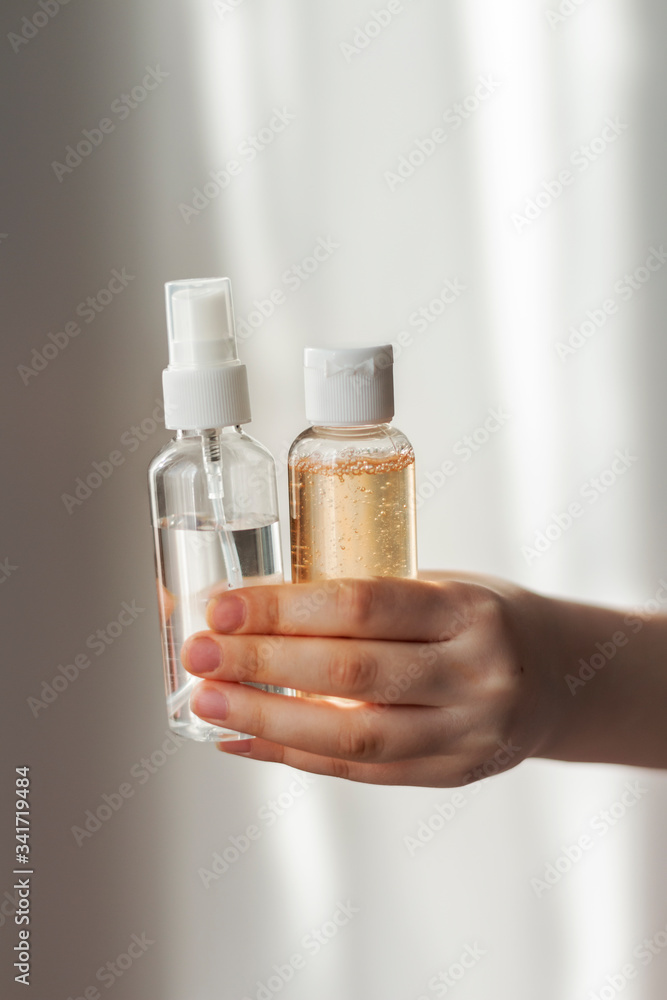 Small plastic containers with antibacterial gels in the hand. Keep hands clean Small plastic containers with antibacterial gels in the hand. Keep hands clean