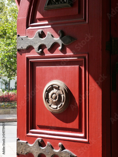 Red old door of the church of Cajica, Boyaca, Colombia photo