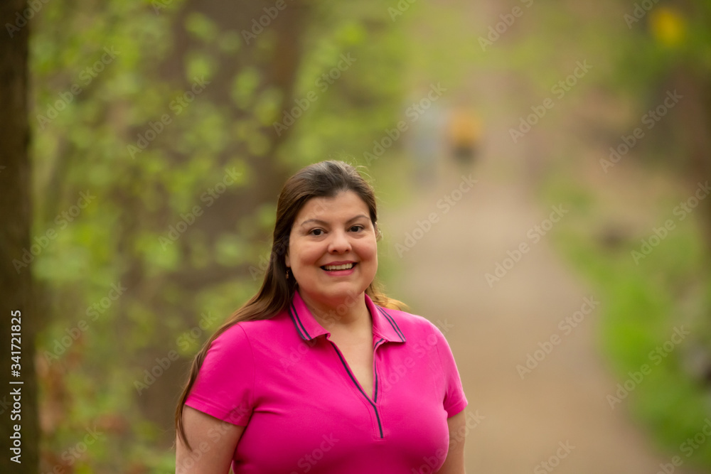 Lady poses for a portrait standing up in the park. Lady poses for a portrait standing up in the park.