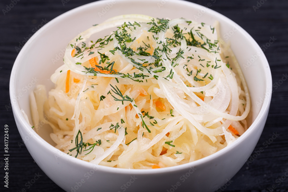 Fermented cabbage with onions and carrots, served with greens Fermented cabbage with onions and carrots, served with greens