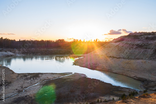 Sunset in the background of an abandoned quarry.
