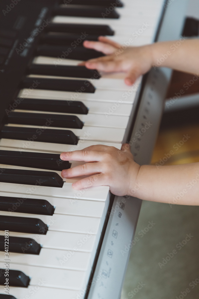 Little girl playing a synthesizer Little girl playing a synthesizer