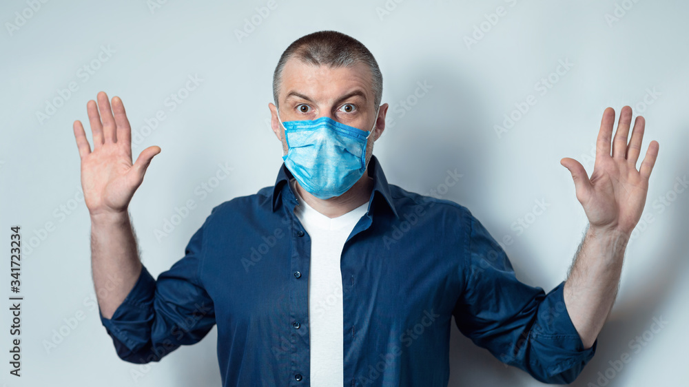 Man In Mask Raising Hands Posing On Gray Background, Panorama Man In Mask Raising Hands Posing On Gray Background, Panorama