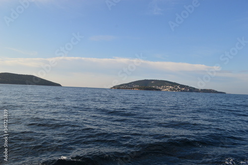 a beautiful view of the sea with tow islands in the background. © hamza