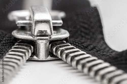 isolated black zipper with metal lock on white background