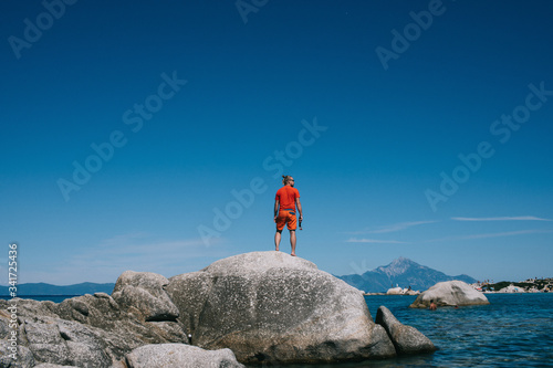 A man standing next to a body of water