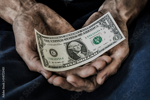 dirty men's hands with a one-dollar bill, poverty, hunger