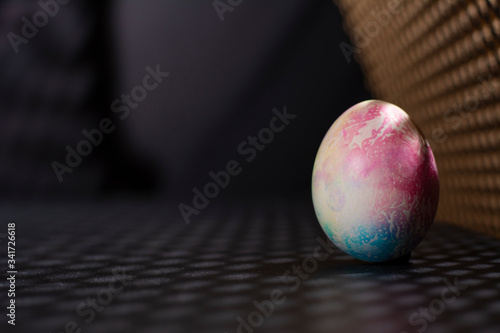 A multicolored egg. Shades of pink, yellow and blue.  photo