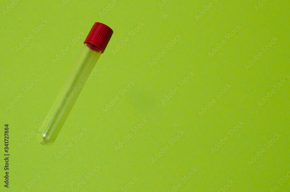 One blood collection tube on a green background One blood collection tube on a green background