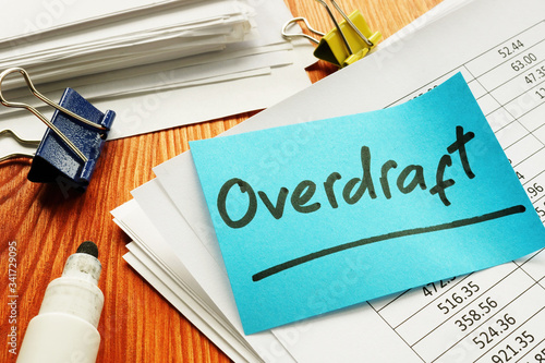 Overdraft sign and stack of accounting documents. photo