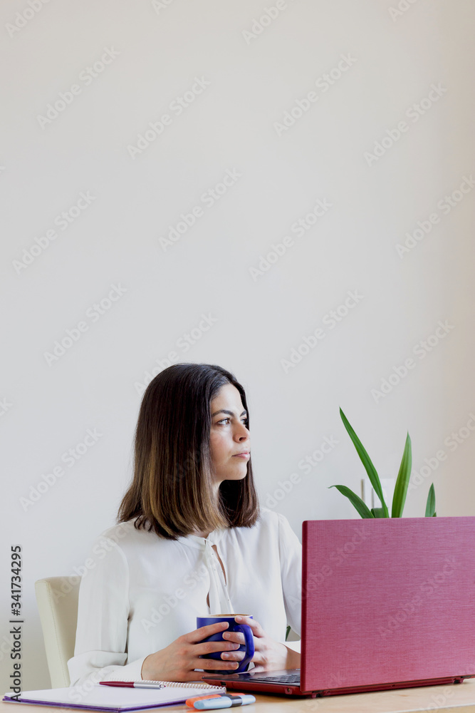 Happy casual woman teleworking from home due to Covid-19 situation. Happy casual woman teleworking from home due to Covid-19 situation.