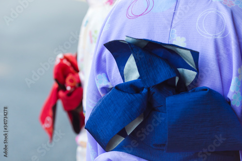 Female Geishas in Traditional Japanese Silk Kimono Walking on Street of Kyoto City,  Japan. photo