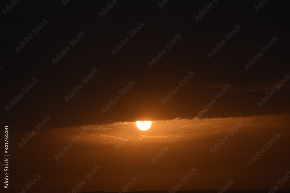 Sunrise in the summer with golden clouds.