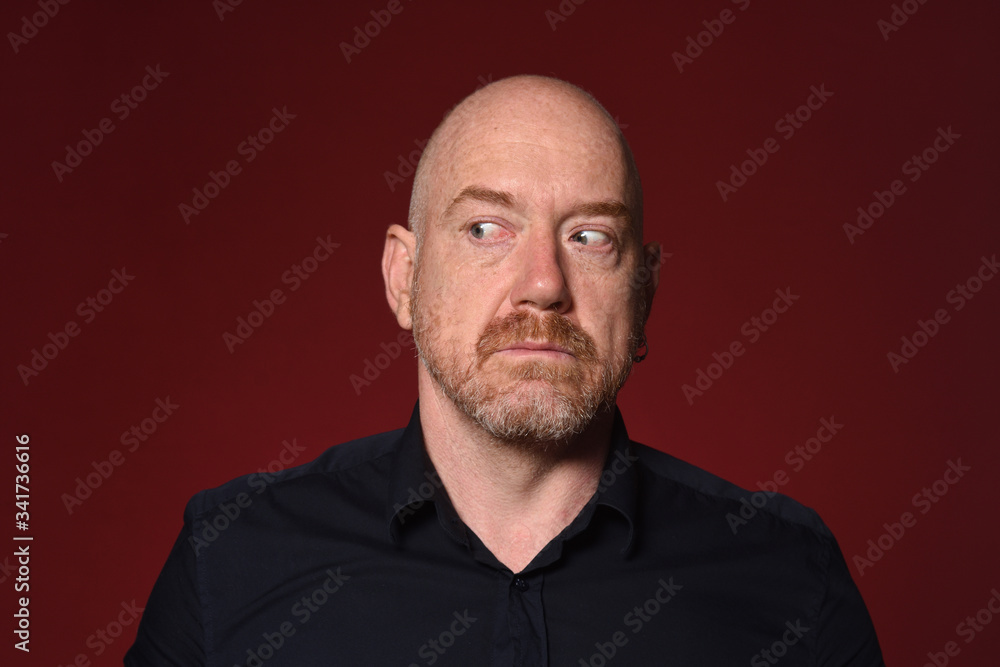 man looking to the side on red background, serious man looking to the side on red background, serious