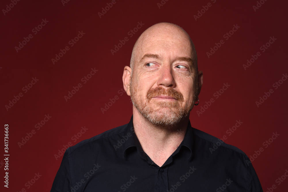 man looking to the side on red background, smiling man looking to the side on red background, smiling