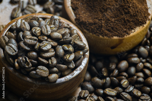 Roasted Coffee beans on grunge wooden can be used as a background