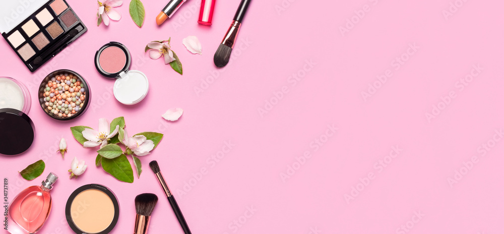 Decorative cosmetics mascara powder lipstick eyeshadow blush balls makeup brush perfume blooming spring branches on pink background top view Flat lay. Beauty blogger concept. Fashion background Decorative cosmetics mascara powder lipstick eyeshadow blush balls makeup brush perfume blooming spring branches on pink background top view Flat lay. Beauty blogger concept. Fashion background