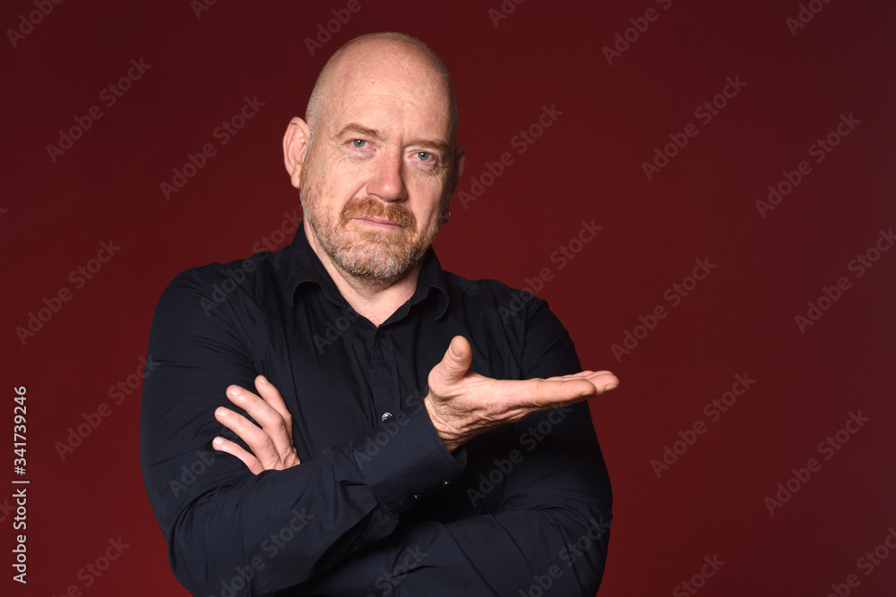 man with hand holding on red background man with hand holding on red background