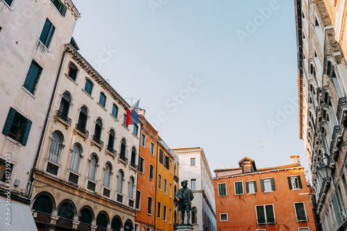 Monument to the playwright Carlo Goldoni on the background of colorful houses | VENICE, ITALY - 16 SEPTEMBER 2018.