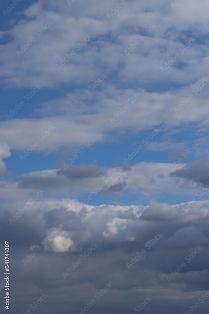 Fototapeta premium Fluffy clouds of the spring sky. Cold sky with clouds.