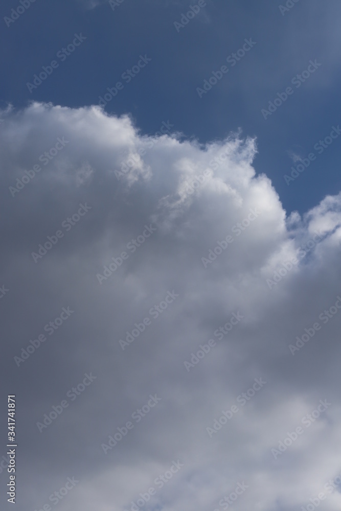 Fototapeta premium Fluffy clouds of the spring sky. Cold sky with clouds.