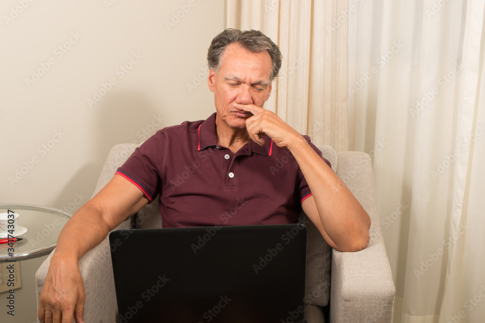 Man working from home on his laptop computer Man working from home on his laptop computer