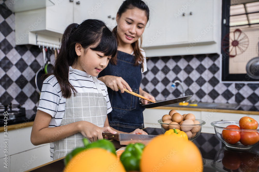 Asian families are cooking  and parents are teaching their daughters to cook in the kitchen at home. .Family activities on holidays and Happy in recreation concept