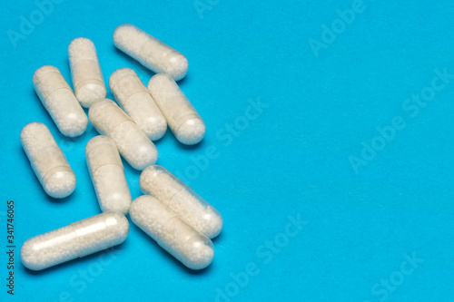 White pills lie on a blue background