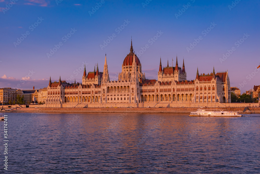 sunset over the river in the city of Budapest with the Parliament