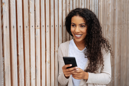Young woman watching off frame with a smile