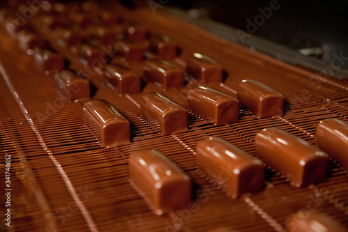 The production of sweet cottage cheese covered with chocolate   