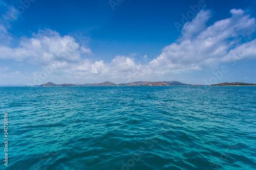 Phi Phi Lay island with tall cliffs and mountains, blue shy and white clouds ,Clear water and mountains,crystal clear Adriatic Sea and Blue Sky with White Clouds 