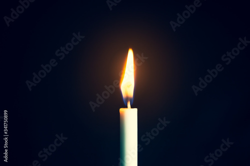 Single lit candle with quite flame, Photos Candle light flame against black background. Concept of memory, remembrance, mourning, grief, and sorrow 