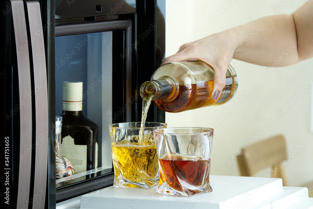 open hatch of a mini bar in a modern refrigerator. home mini bar in the
