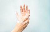 
Soapy hands on a blue background