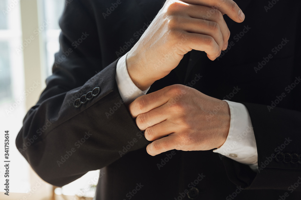Fototapeta premium Wearing black jacket. Close up of caucasian male hands, working in office. Concept of business, finance, job, online shopping or sales. Copyspace for advertising. Education, communication freelance.